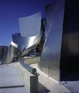 A building with a large metal structure on the side of it.