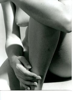 A black and white photo of a nude woman.