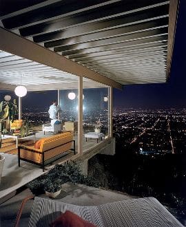 A house with a view of the city at night.