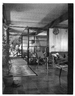 An old black and white photo of a living room.