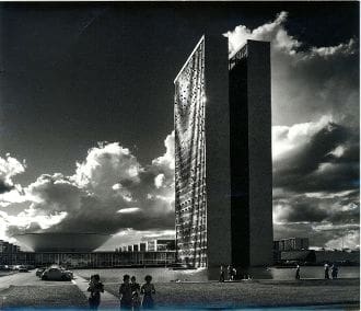 A black and white photo of people on the beach