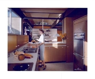 A kitchen with many wooden cabinets and counters