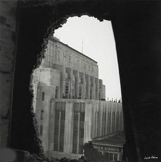 A view of buildings from inside an old building.