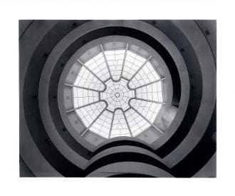 A black and white photo of the inside of an atrium.