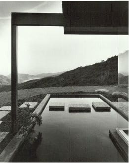 A black and white photo of an outdoor pool.