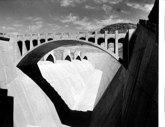 A black and white photo of the bottom of a dam.