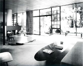 A black and white photo of an open living room.