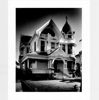 A black and white photo of an old house.