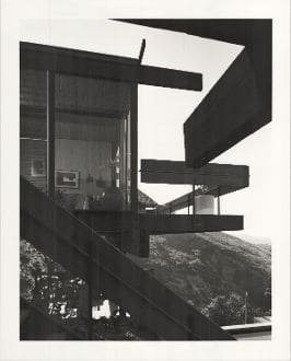 A black and white photo of stairs leading to the top floor.