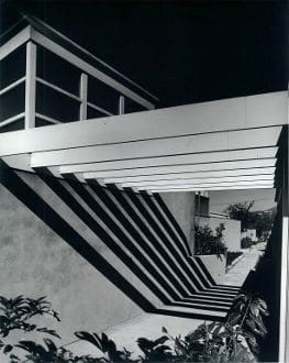 A black and white photo of stairs at night.