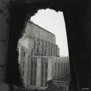 A view of buildings from inside an old building.