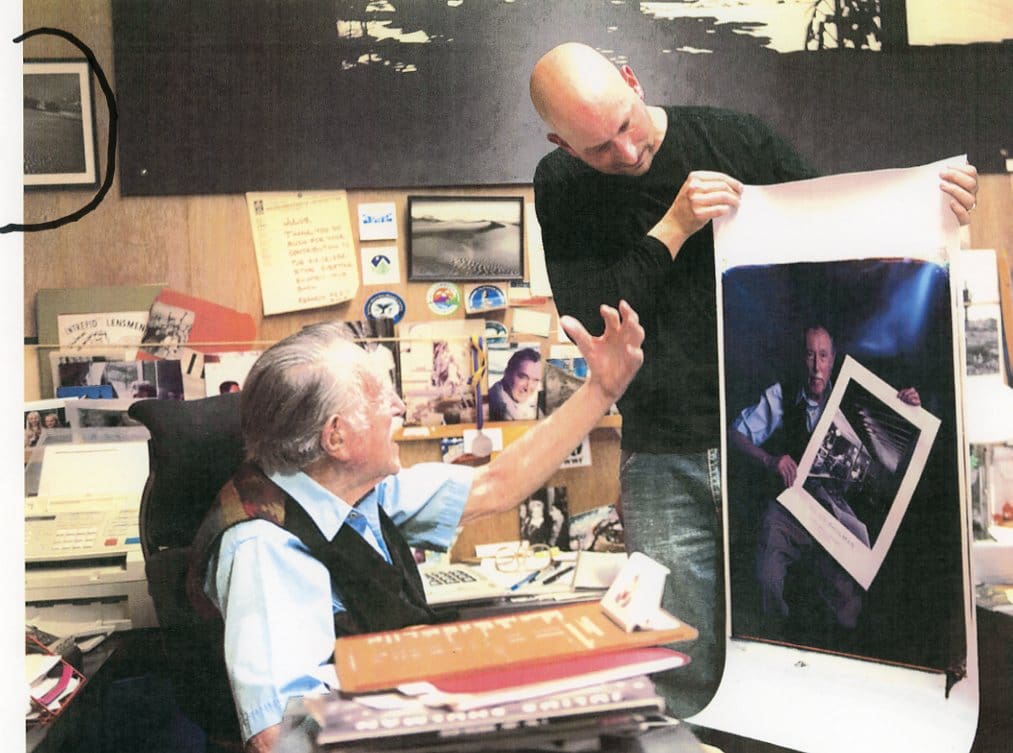 Photographer showing large print to elderly man