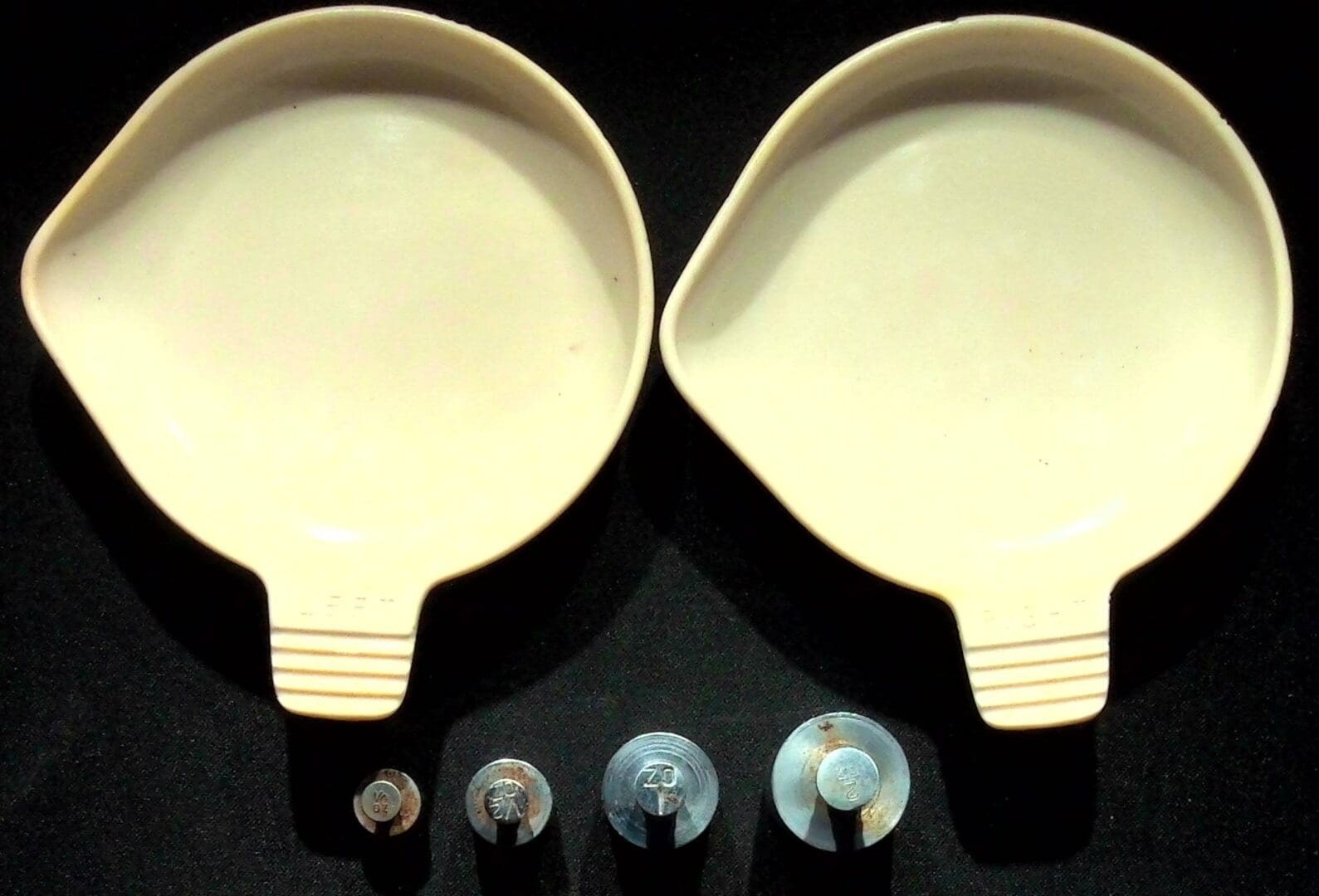 Two cream scoops with metal washers