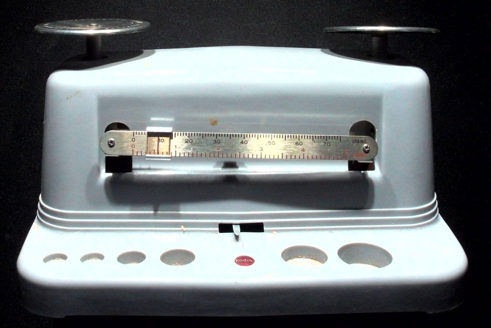White vintage balance scale with metal pans