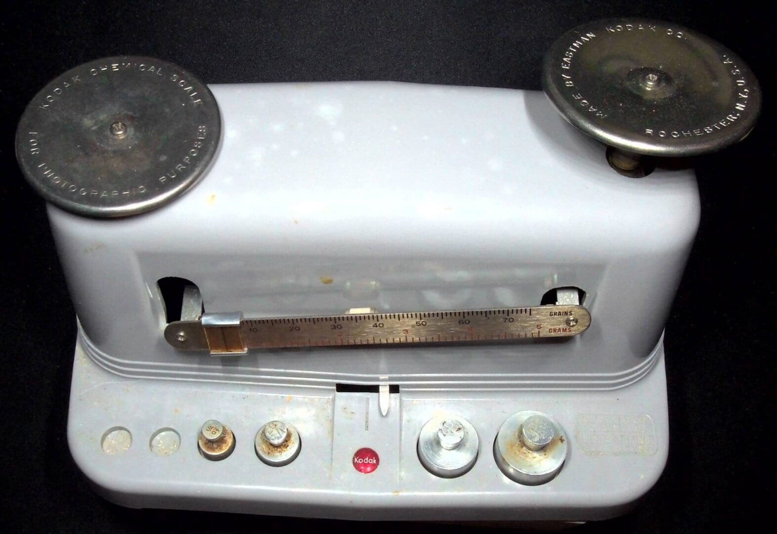 Vintage white postal scale with metal weights