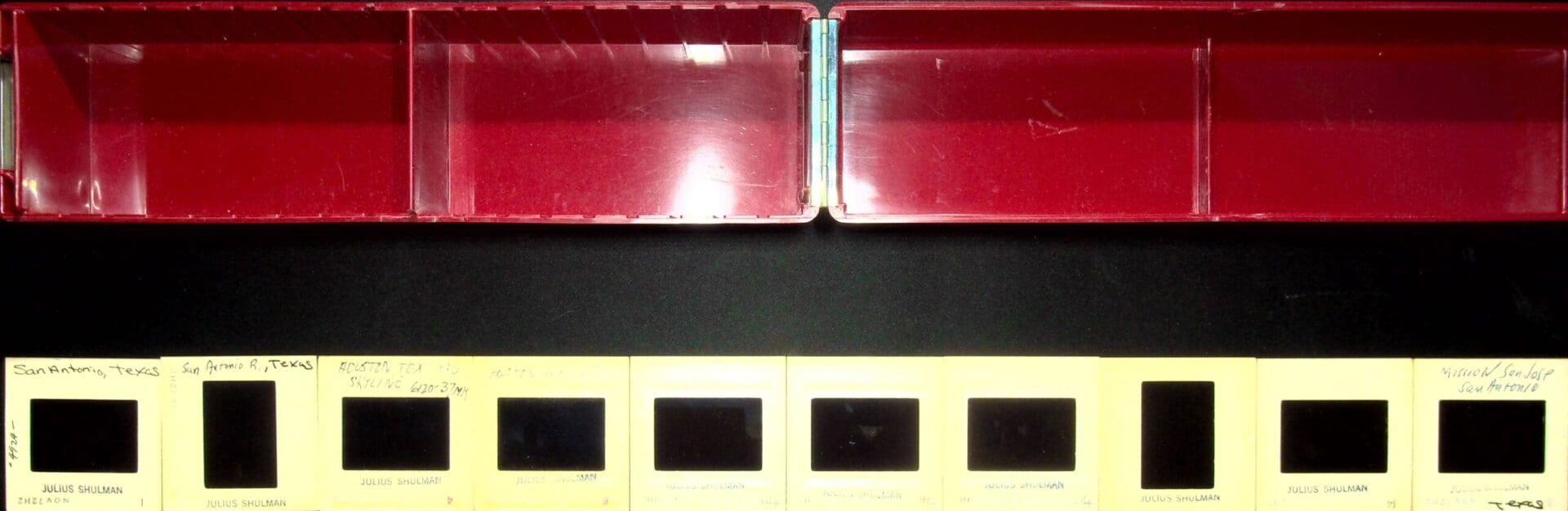 Vintage photographic slide mounts under red boxes