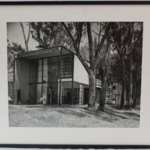 Framed black-and-white photo of modern glass house