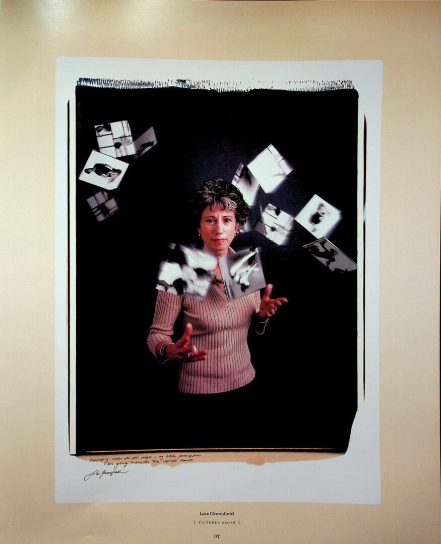 Person tossing floating photographs against black background