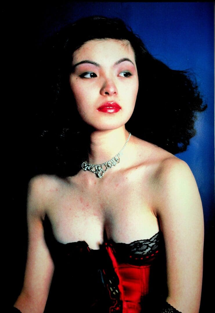 Woman wearing red corset and necklace